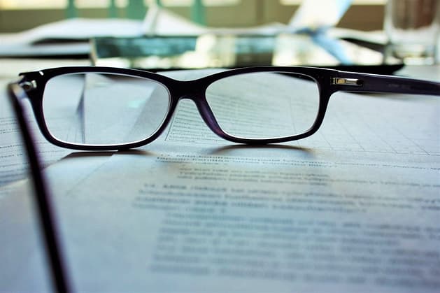 an image of a pair of glasses sat on top of paperwork 